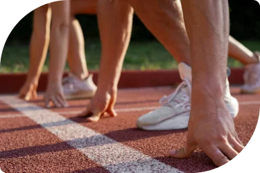 Athletes preparing at the starting line on a professional running track during competition training